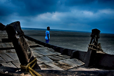 Man standing at beach against sky