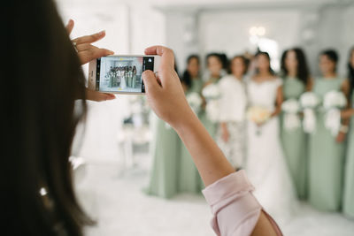 Close-up of woman photographing with mobile phone