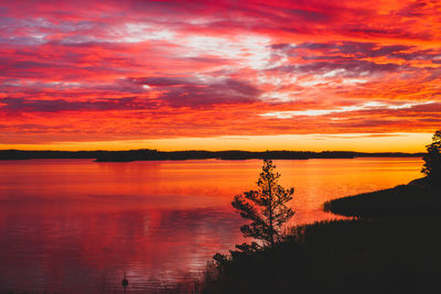 Scenic view of lake against romantic sky at sunrise