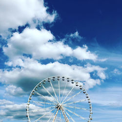 Low angle view of ferris wheel against sky