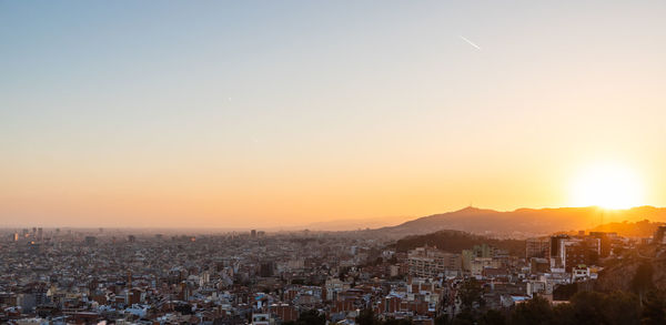 Aerial view of townscape against sky during sunset