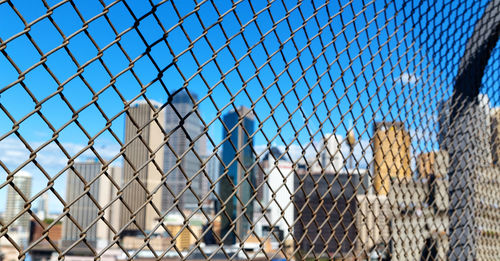 Chainlink fence against blue sky