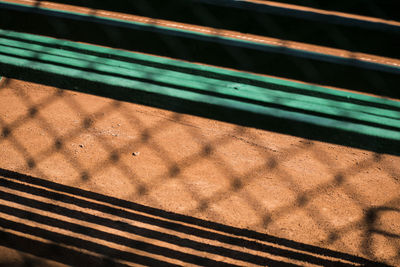 High angle view of shadow on railing