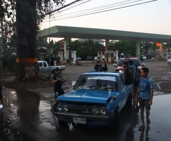 People on street in city against sky