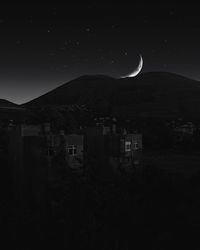 Scenic view of buildings against sky at night