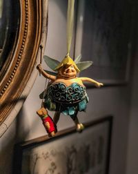 Low angle view of statue hanging on ceiling at home