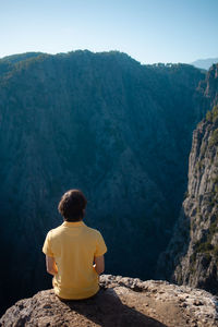 Rear view of man looking at mountains