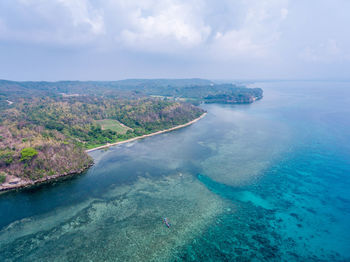 Aerial view of sea against cloudy sky