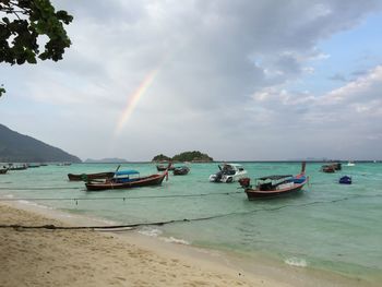 Scenic view of boats moored on sea against sky