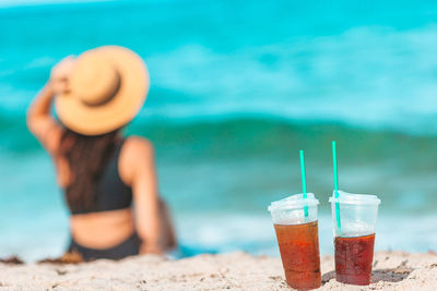 Rear view of woman wearing hat on beach