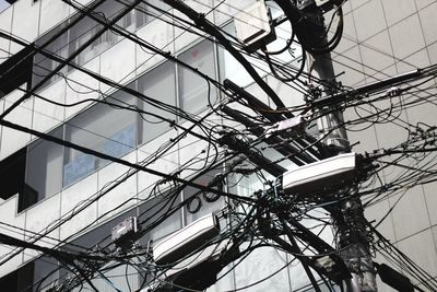 Low angle view of electricity pylon against sky