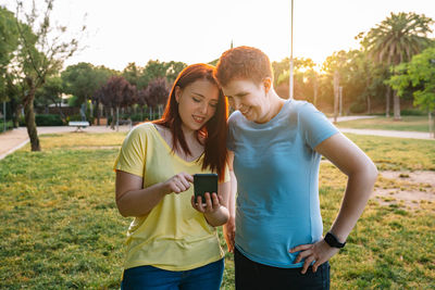 Lesbian couple looking at mobile phone