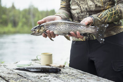 Woman holding caught fish