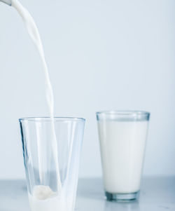 Close-up of drinking glasses against white background