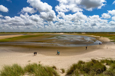 Scenic view of sand dune against sky