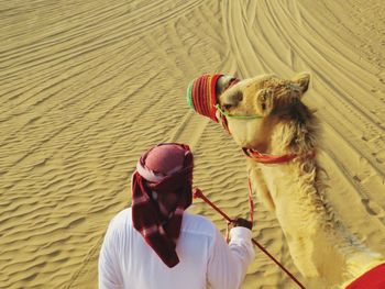 Man with camel in desert