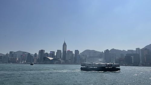 Boats in sea against clear sky