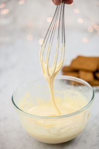 Close-up of wire whisk stirring cream