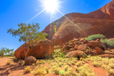 Scenic view of rocky mountains against sky on sunny day