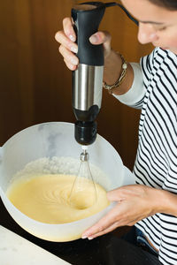 Woman kneading the dough while cooking apple pie in the modern kitchen