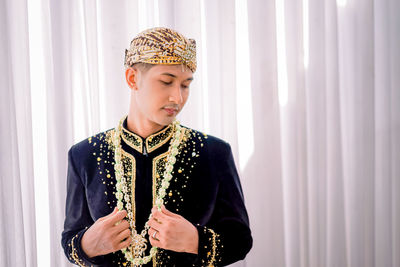 Asian man wearing traditional clothes,beskap is traditional heritage clothes from java,indonesia 