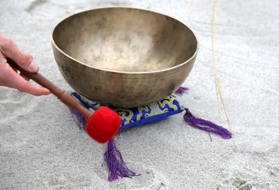 Cropped hand playing singing bowl