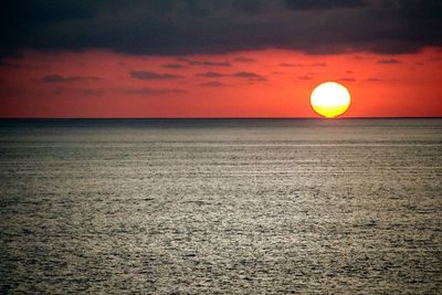 Scenic view of sea against orange sky