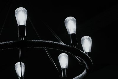 Close-up of light bulb against black background