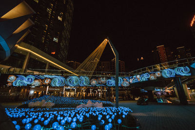 Low angle view of illuminated building against sky at night