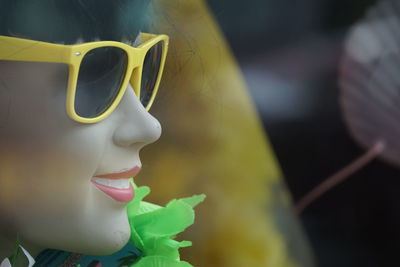 Close-up of young woman wearing sunglasses