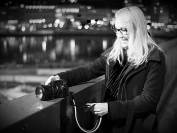 Woman with umbrella at night