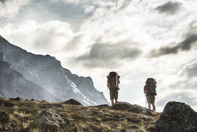 Low angle view of two backpackers on an alpine hillside