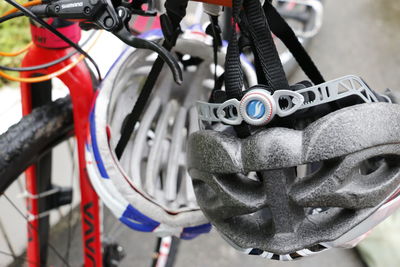 Close-up of helmets hanging from bicycle