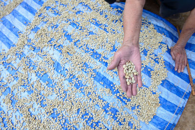 High angle view of hands on rug