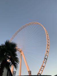 Low angle view of ferris wheel against clear sky