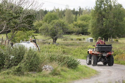 Male farmer driving four-wheeler