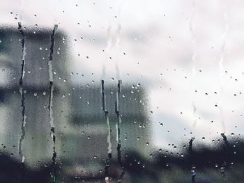 Close-up of wet glass window in rainy season