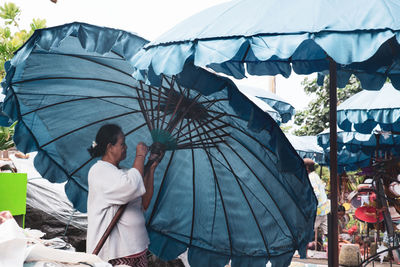 Rear view of people standing outdoors