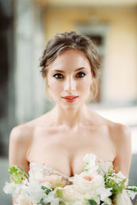 Portrait of young woman with bouquet