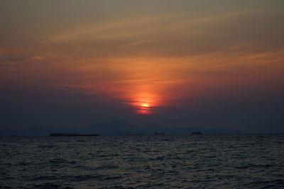 Scenic view of sea against orange sky