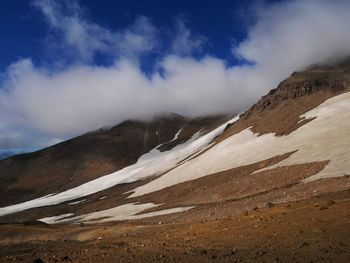 Scenic view of snow covered mountains against sky