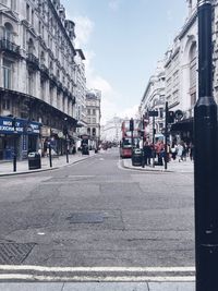 People walking on road along buildings