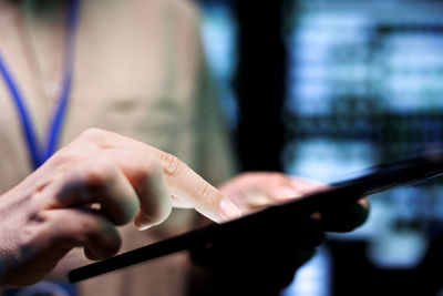 Midsection of woman using mobile phone