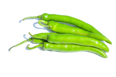 Close-up of green chili pepper against white background