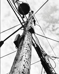 Low angle view of telephone pole against sky