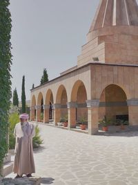 People outside temple against building