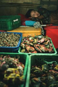 Woman for sale at market stall