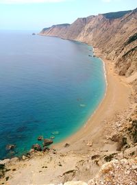 Scenic view of beach against blue sky