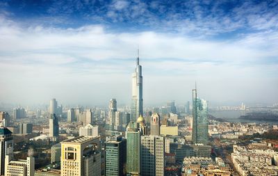 Cityscape against cloudy sky