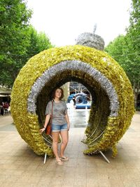 Young woman standing by decoration